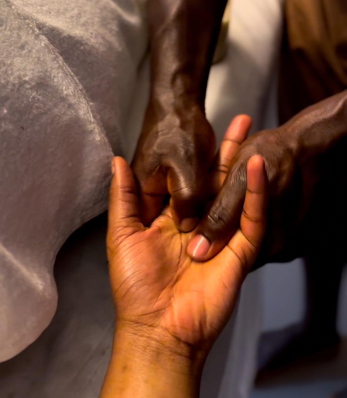 A massage therapist performing a relaxation massage on a client in a tranquil spa room with soft lighting and relaxing decor
